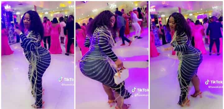 “Can’t stop watching” – Curvy lady in heels and tight dress makes many lose focus as she whines waist at event (Video)