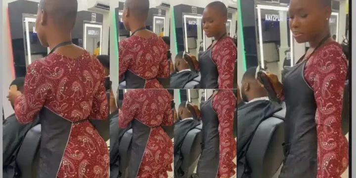 “U dey do home service abeg?” – Reactions as curvy lady barber whines waist as she trims customer’s hair (Video)