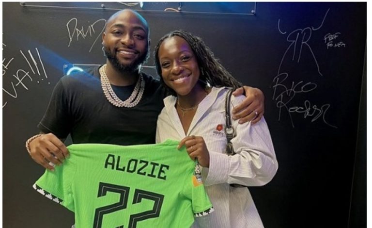 “Don’t give her belle O” – Fans react as Davido gets customised Jersey from Super Falcon’s Alozie (Photo)