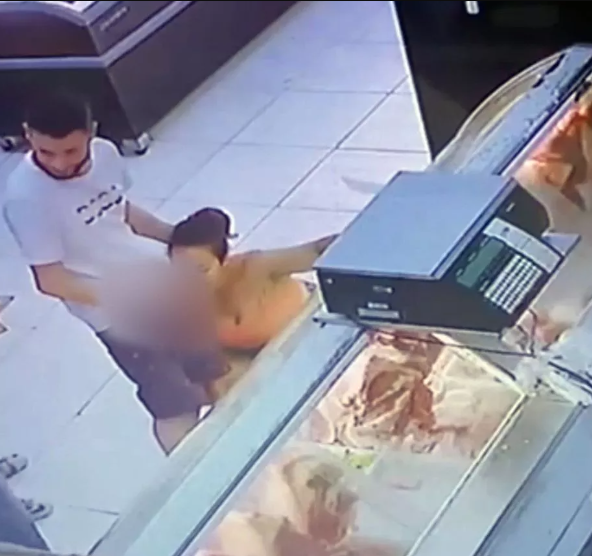 Woman bends to perform 0ral act on man at meat section of supermarket as workers stare in horror (video)